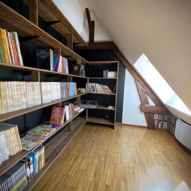 Pose de crémaillères et de consoles double cran, puis pose et fixation d'étagères en mélaminé, imitation chêne. Installation de séparations pour le support des livres.